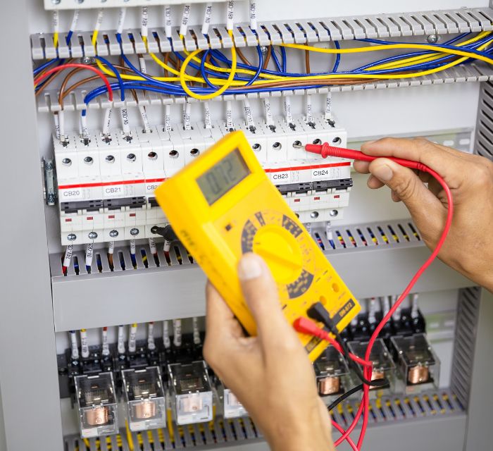 HVAC Technician Testing An Electrical Panel