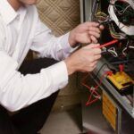 HVAC technician repairing a furnace