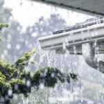 Drenching downpour rain with storm water overflowing off a roof